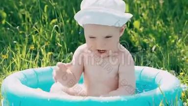 夏天，小男孩在充气游泳池里嬉笑打闹
